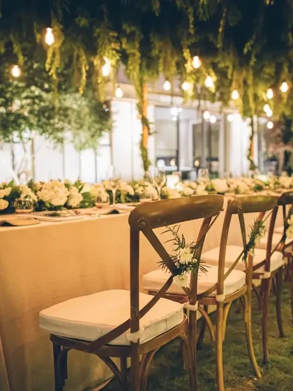 Another view of the beautifully arranged chairs and table at the outdoor garden event.