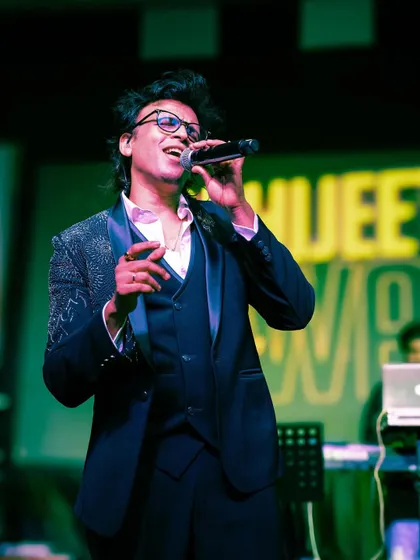 When it's time to suit up, we deliver. Here's singer Abhijeet Sawant looking sharp on stage in one of our embellished tuxedos. This three-piece suit with detailed lapels is perfect for any high-profile performance or formal event.