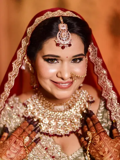A close-up of this bride's radiant smile. The makeup is designed to enhance her happiness, with a flawless base and sparkling eyes.