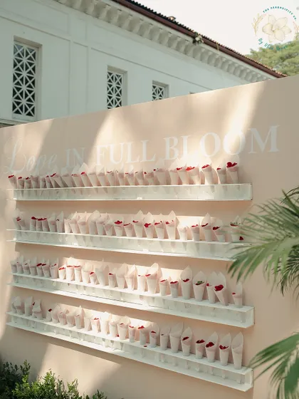 A 'Love in Full Bloom' wall, where guests can take cones of petals to shower the couple. It's a beautiful, interactive decor element that also makes for a great photo opportunity.