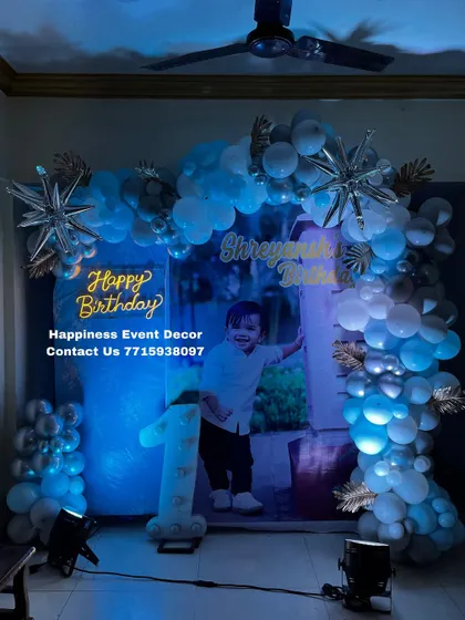 A slightly different lighting angle on the blue and silver first birthday decor, showing how the mood can be adjusted with the LED par lights I provide.