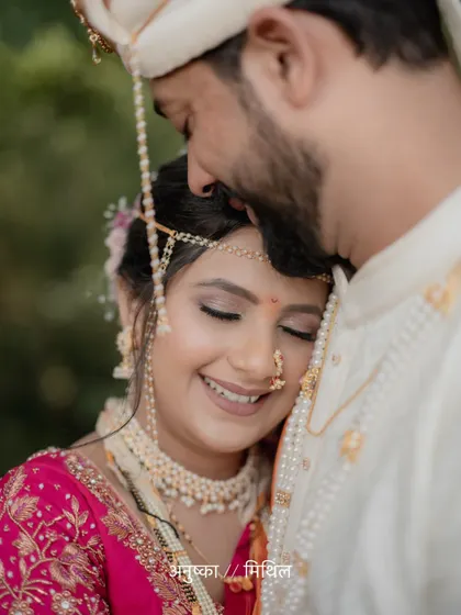 A close-up portrait capturing the bride's serene smile as she rests against her groom, a moment of pure bliss.