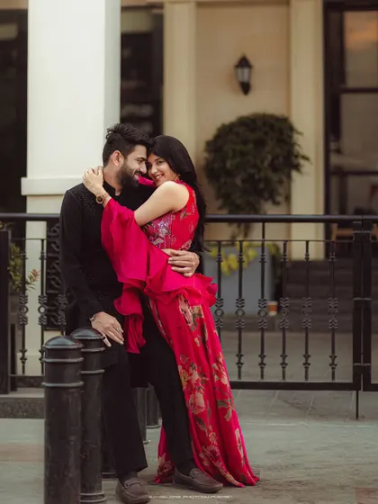 A pre-wedding shoot with a fashionable flair. The couple's stylish outfits and romantic interaction make for a beautiful, modern portrait.