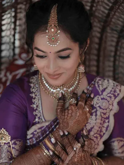 A close-up on the details, showing the intricate henna and the soft, flawless makeup that completes her engagement look.