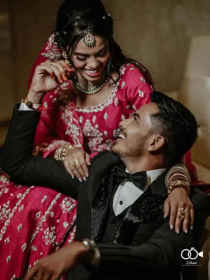 A candid moment of shared laughter between the couple during their glamorous reception. Dressed in their finest, this image captures the joy and elegance of the evening's celebration.