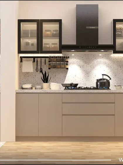 The kitchen from the 'Sobha Daisy' project. It features minimalist beige cabinets, a terrazzo backsplash, and a mix of open and closed storage, creating a light and modern feel.
