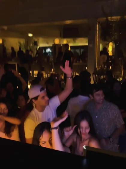 The crowd at Pangeo with their hands in the air, completely into the music.