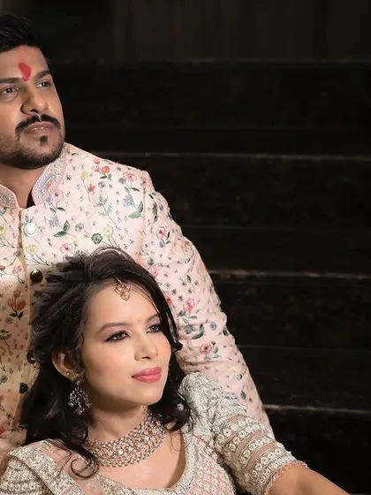 A regal and poised portrait of the couple on their engagement day, seated and looking away, creating a classic and thoughtful image.