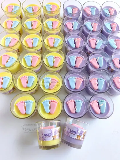 A colorful array of baby feet votive candles in lilac and yellow, made for a teddy bear themed baby shower. Each one is ready for its personalized sticker.