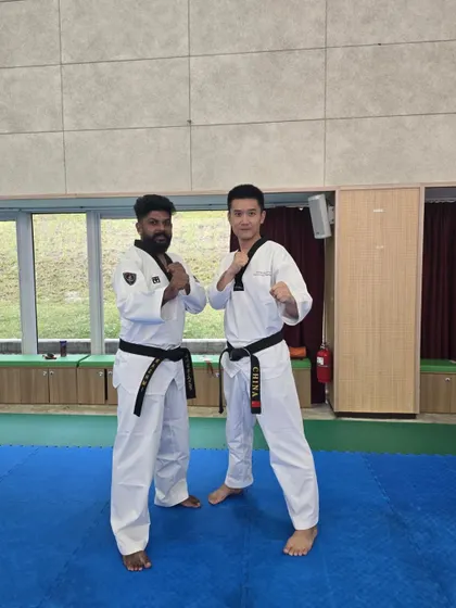With a fellow coach from China, united by the spirit of martial arts.