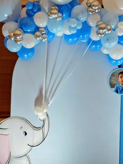 A detail shot showing how I create a parachute effect with fabric and balloons, held by a cute elephant cutout.