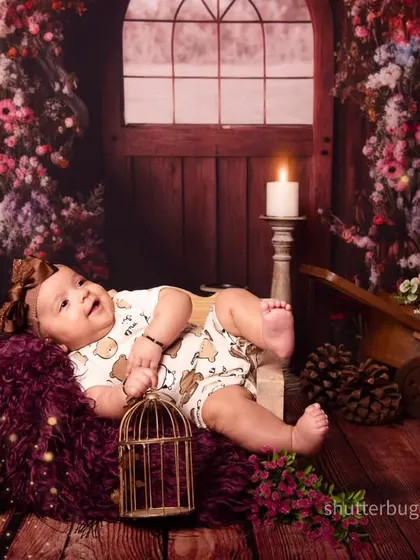 This happy three-month-old is enjoying the view from her cozy seat in our enchanting floral woods setup.