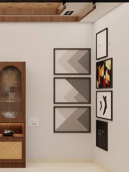 A detail shot of the gallery wall next to the crockery unit. The mix of geometric and abstract prints adds a modern, artistic touch to the dining space.