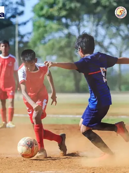 An action shot of Swarit Satpute shielding the ball from an opponent during a competitive state league match.