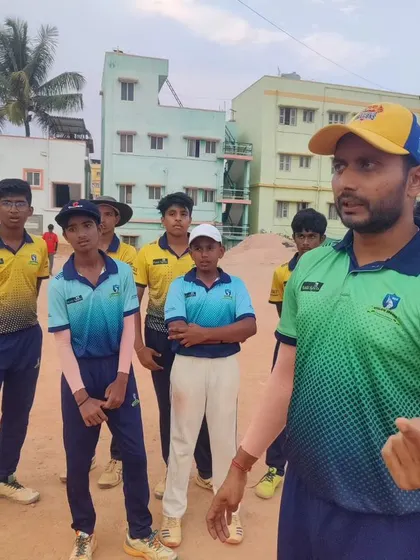 A coach debriefs his team after a session. We encourage open communication and tactical discussions to help players understand the game on a deeper level.