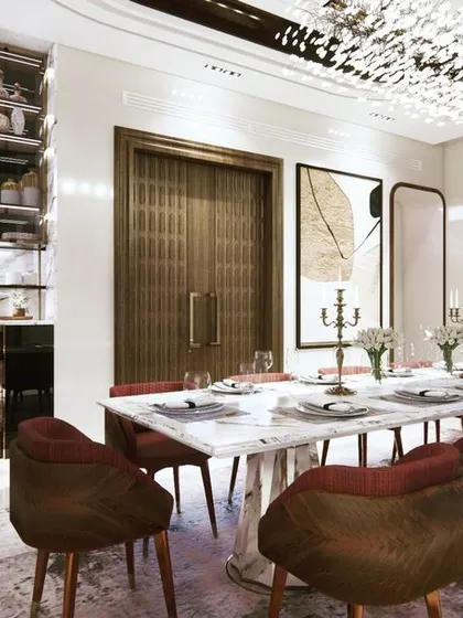 This dining room combines luxurious materials for a grand statement. The design features a stunning marble-top table, rich leather chairs, a custom crockery unit, and a breathtaking crystal chandelier that elevates every meal into a special occasion.
