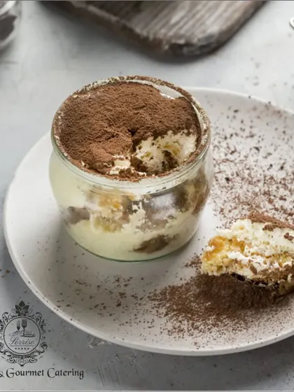 A deconstructed view of my classic Tiramisu in a jar. You can see the distinct layers of coffee-soaked sponge and light, airy mascarpone cream, ready to be enjoyed.