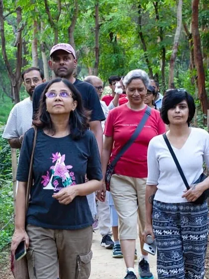 Participants on a community walk at Aravali Creek look up in wonder at the lush canopy, a welcome sight in the middle of the city.