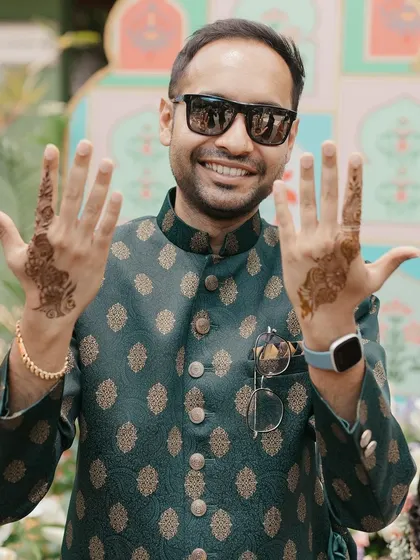 The groom proudly shows off his Mehendi design, a modern trend that I love to incorporate to make the groom feel just as involved.