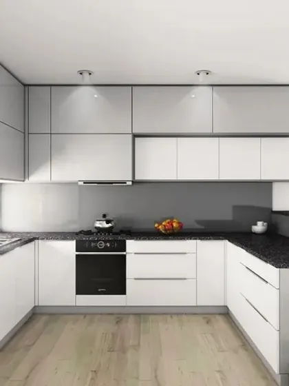 A minimalist U-shaped kitchen in all-white high-gloss cabinetry. The handleless design and integrated appliances create an ultra-clean and seamless look, perfect for modern homes.