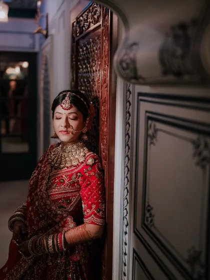 Sometimes the most powerful moments are the quiet ones. I took this portrait of Khyati just before her ceremony, a serene moment of reflection. My photography focuses on capturing both the grand celebration and the bride's inner emotions.