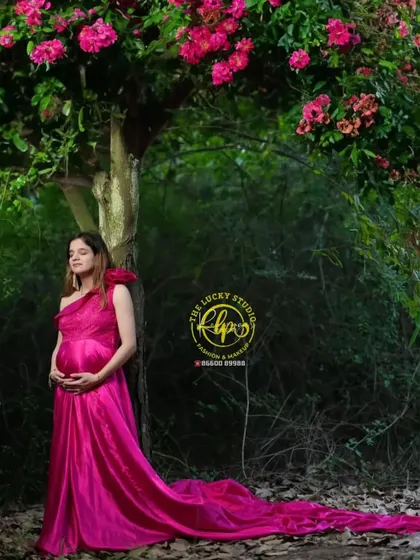 A quiet, reflective moment under a flowering tree. The rich colour of the gown and the soft, natural makeup come together to create a truly memorable maternity portrait.