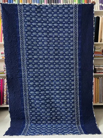 The reverse side of the indigo saree quilt, featuring a simpler pattern that complements the front.