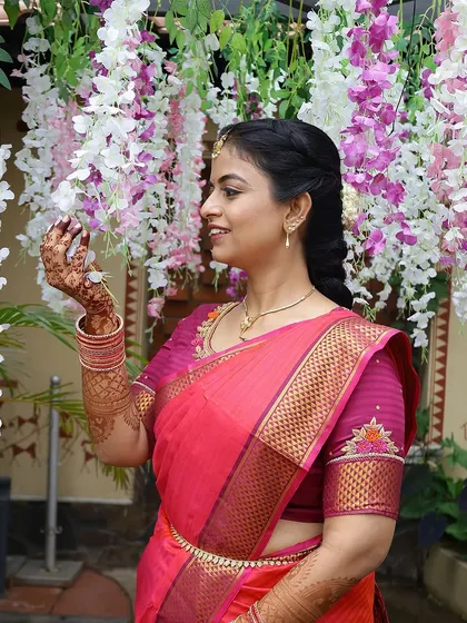 The bride admiring the flowers, her elegant mehendi stain adding to the beauty of the moment.