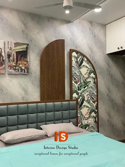 A closer look at the "Go Green" guest bedroom headboard, showing the interplay of the tufted upholstery, the diagonal wood panel, and the vibrant botanical print panel.