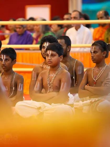 Young Vedic students sit in meditation during the Maha Sudarshan Homa. Their focused presence adds to the powerful and serene atmosphere of the ceremony.