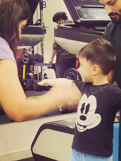 A close up of a pediatric physiotherapy session. The therapist and parent work together to encourage the child, creating a supportive and positive environment for them to conquer new milestones.