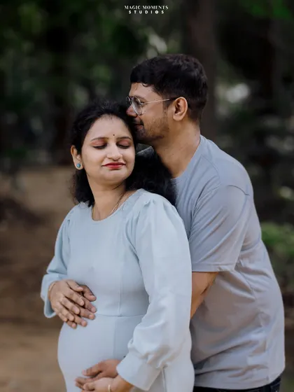 A warm embrace from behind. This pose is comforting and intimate, showing the supportive role of the partner during the pregnancy journey.