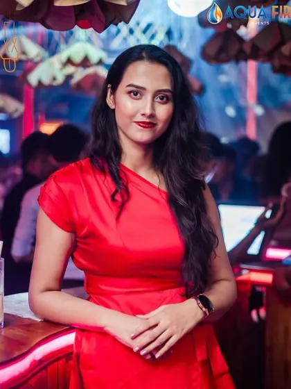 A guest in a stunning red dress, adding a splash of color to the party at The Fixx.