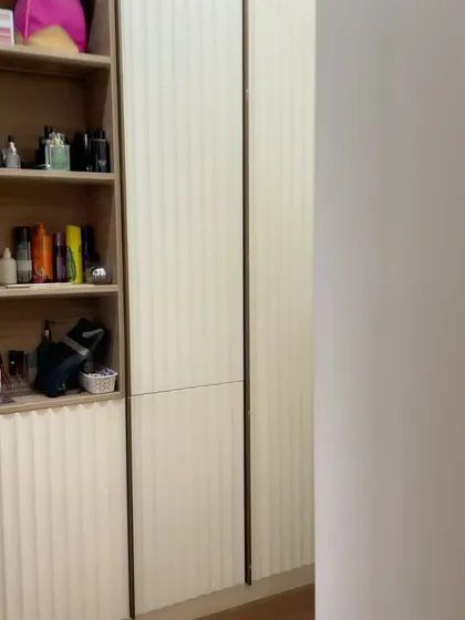 A side view of the fluted wardrobe, showing the open shelving section perfect for perfumes and accessories.