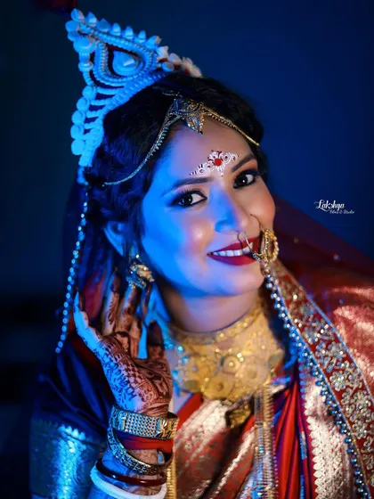 A stunning bridal portrait with dramatic blue lighting. The bride's confident look and beautiful smile are highlighted, creating a memorable and modern photo.