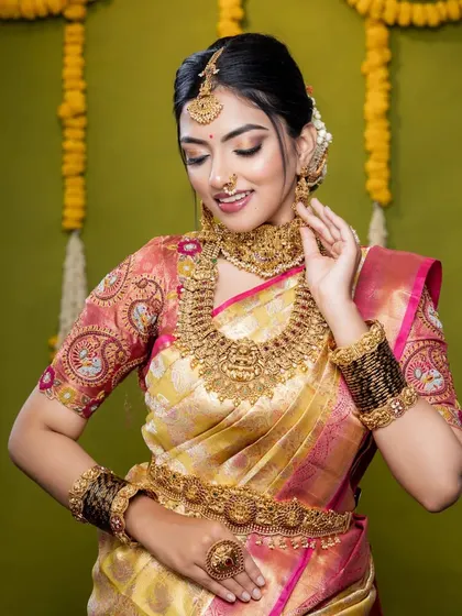 A candid moment showing the bride's joy. The antique gold finish of the jewellery gives it a timeless, heirloom quality.