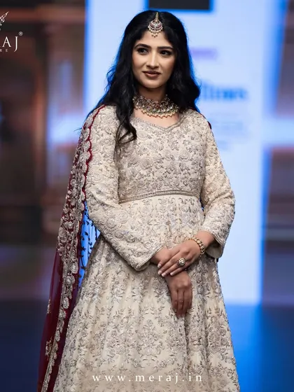 A close-up of the showstopper, her regal ensemble captivating with its ornate details and graceful drape.