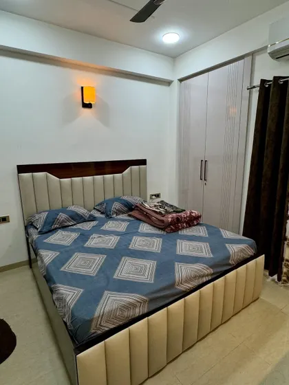 Another angle of the bedroom, showing the placement of the bed and wardrobe. The simple design is clean and timeless.