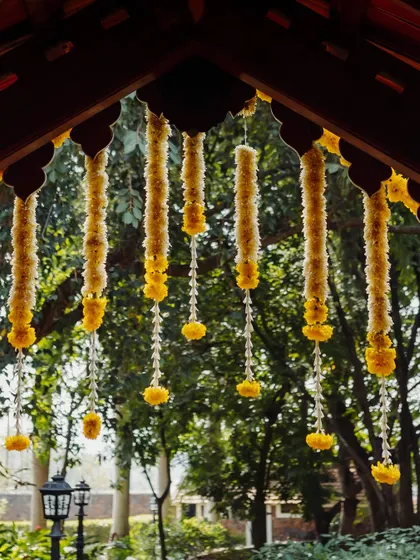 Hanging floral strings of marigold and tuberose, a classic decor element for traditional Indian events.
