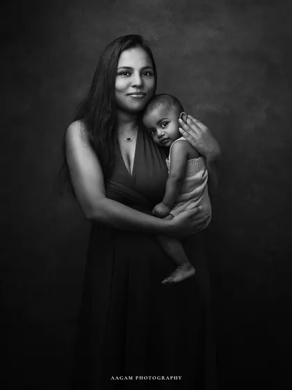 A mother and child fine art portrait in black and white. The monochrome tones add a layer of emotional depth and timelessness to their loving embrace.