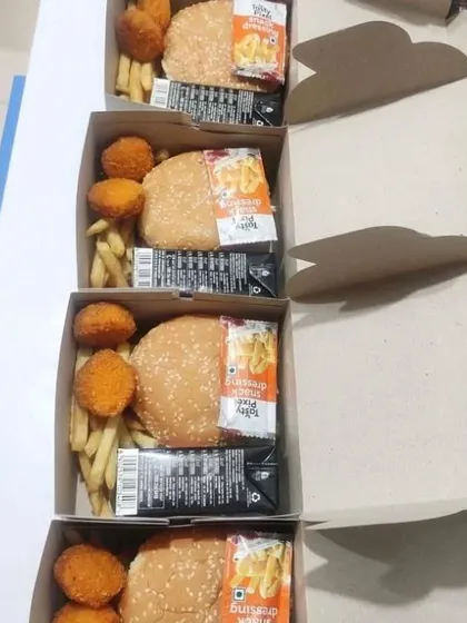Our snack boxes are not just about traditional Indian fare. We also offer fun options like these boxes with a veg burger, cheese nuggets, and french fries, making them a hit at birthday parties and casual corporate events.