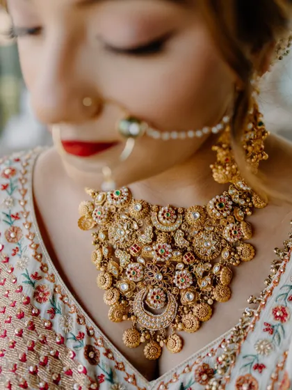 A detailed shot of the bride's intricate gold jewelry. I believe in capturing the small details that complete the bridal look and hold sentimental value.