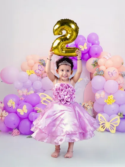 Leveling up to TWO! This butterfly-themed second birthday shoot is filled with purple and pink balloons, capturing the magical transition into toddlerhood with style and a big smile.