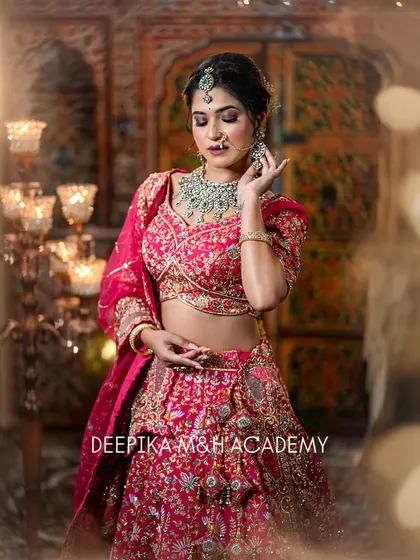A beautiful shot of the bride looking down, with soft lighting creating a dreamy effect. The focus is on her elegant posture and stunning outfit.