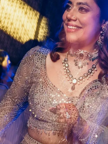 A vibrant shot of the bride dancing, with blue and yellow lights creating a cool, energetic vibe.