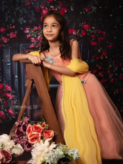 A thoughtful and elegant pose from a toddler during her floral-themed studio session.