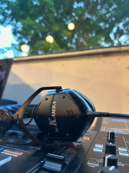 A close-up of my custom headphones on the console. This is my essential gear for every wedding gig.