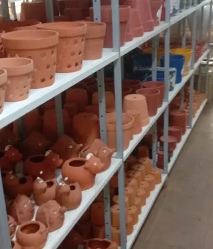 A look at our collection of classic terracotta pots, including standard shapes, orchid pots with ventilation holes, and whimsical animal-shaped planters.