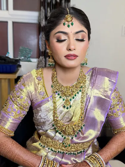 My beautiful bride Hamsa. This look features a soft, blended eye makeup and a subtle lip, perfectly complementing her light purple and gold saree.