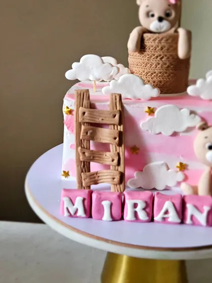 A close-up of the half-birthday cake, showing the detail on the edible wooden ladder and the name blocks.